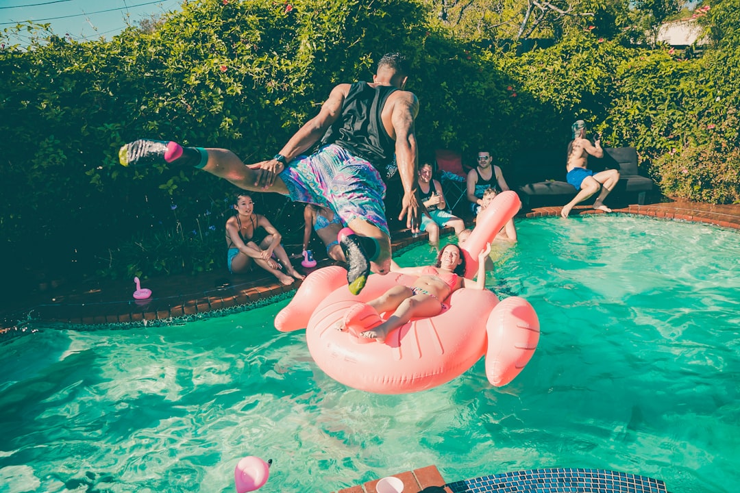 Family enjoying pool party in backyard
