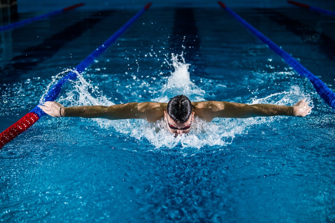 Man swimming in professional indoor competition pool