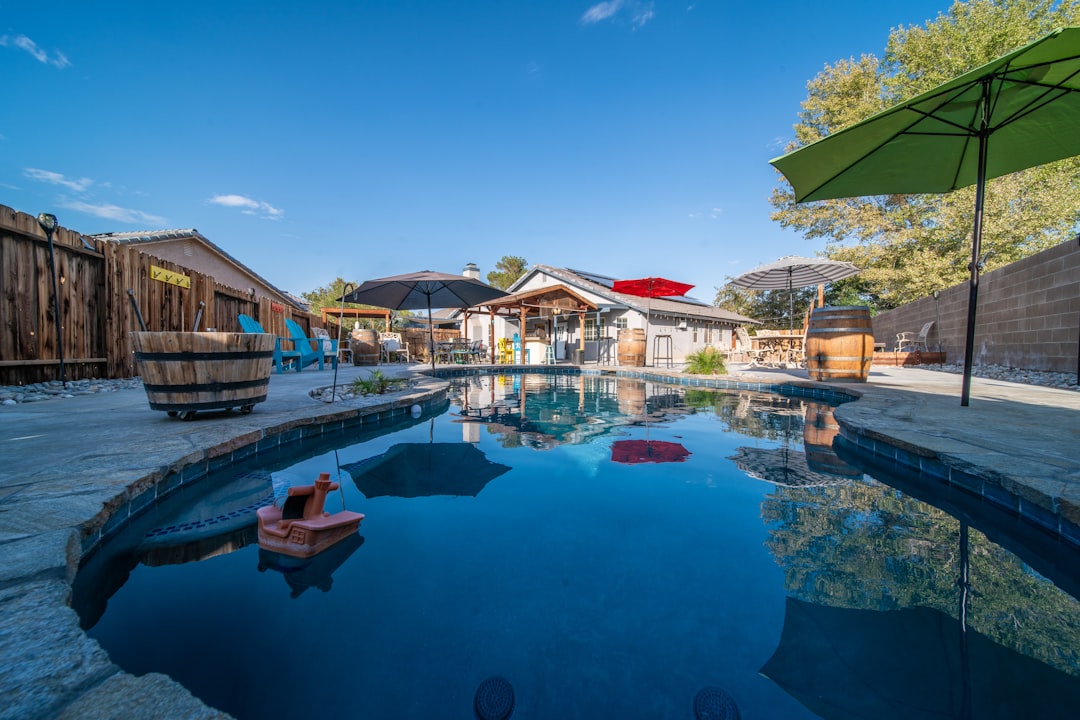 Swimming pool with umbrella and lounge chairs