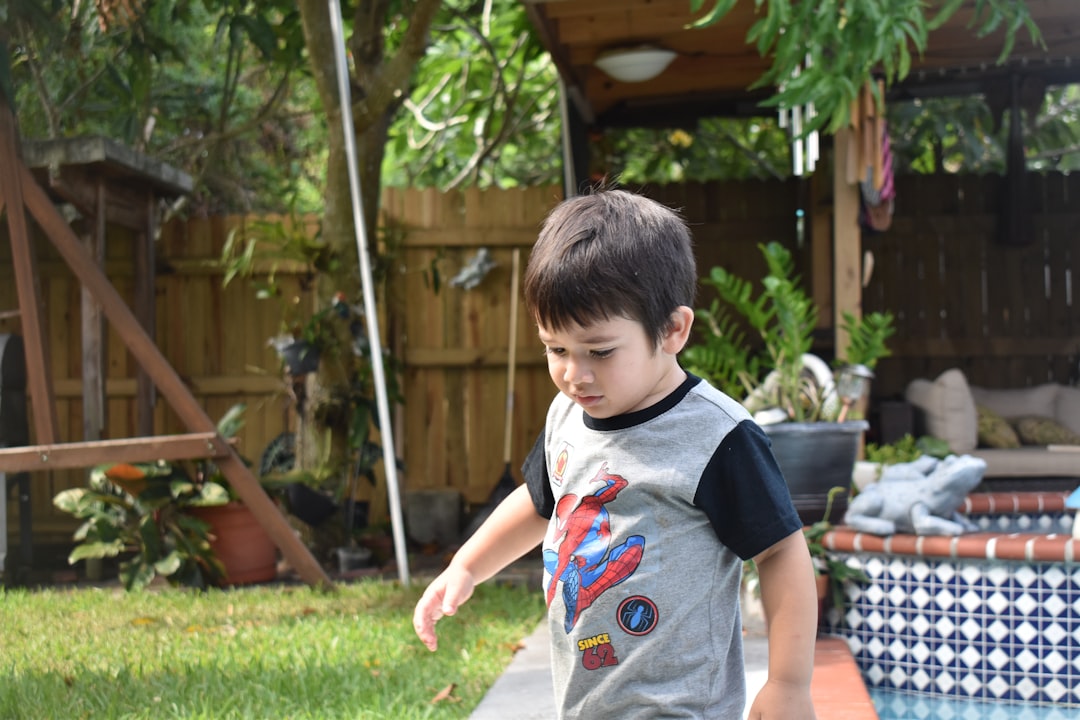 Happy child playing in backyard pool